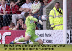 The ball takes a deflection off Chorley past Jones  for the second goal against Huddersfield.