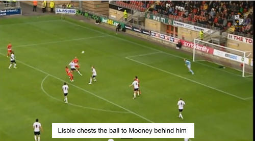 Lisbie chests the ball to Mooney behind him