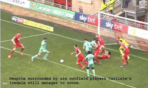 Despite surrounded by six outfield players Carlisle’s Iredale still manages to score.